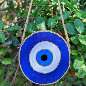 Evil eye painting on a hanging wood slice - wall decor